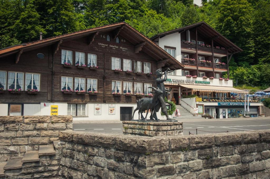 a statue of a horse in front of a building at Hotel Weisses Kreuz in Brienz