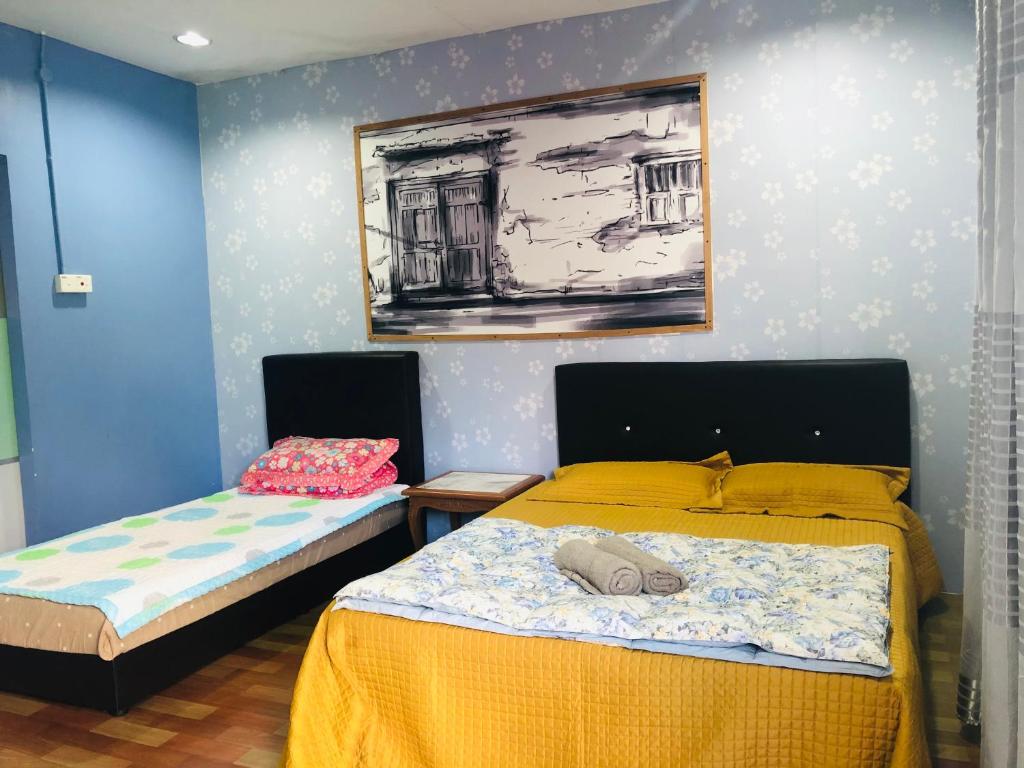 Postel nebo postele na pokoji v ubytování WAN'S ROOMSTAY LANGKAWI