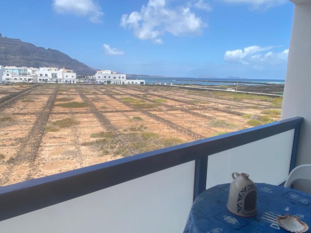 a view of a field from a balcony at Apartamento Salinas del Mar in Orzola