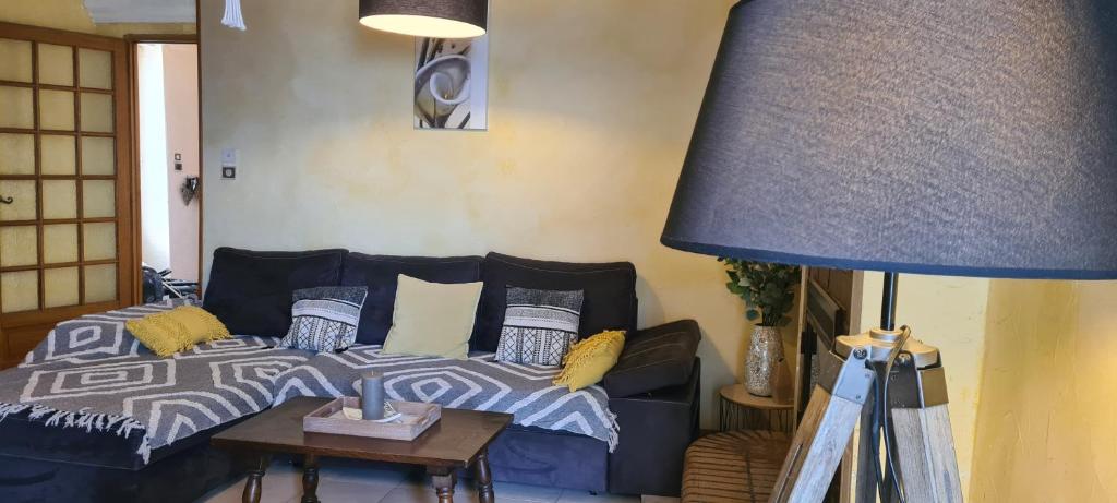 - un salon avec un lit et une lampe bleue dans l'établissement maison de village T4, à Poggio-dʼOletta