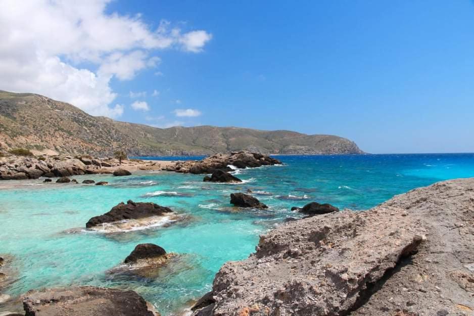 a view of a beach with rocks and the ocean at Kedrodasos House in Elafonisi