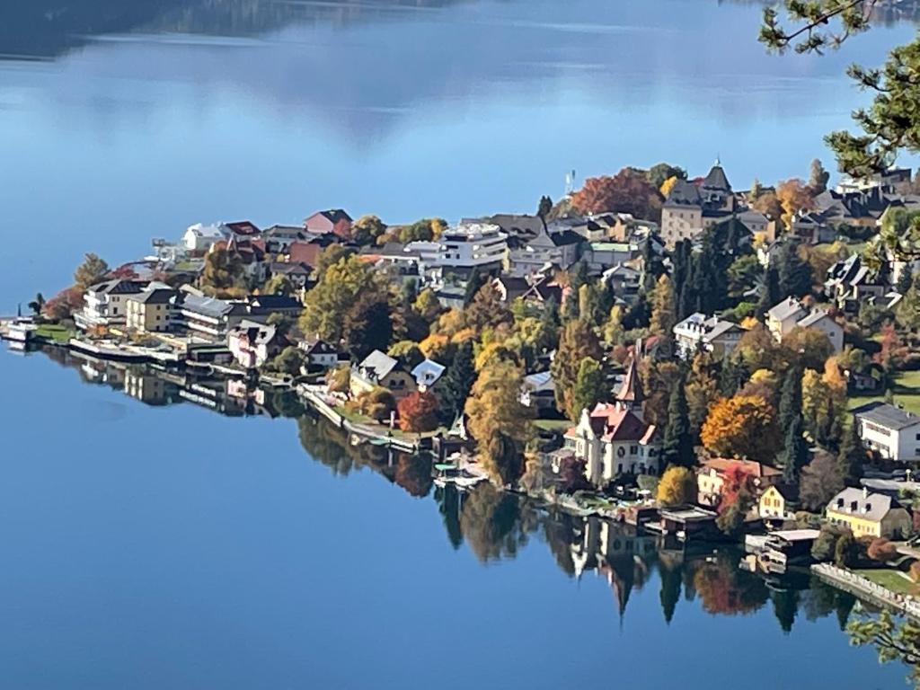 a town on a river with houses and trees at Seeblick Millstatt in Millstatt