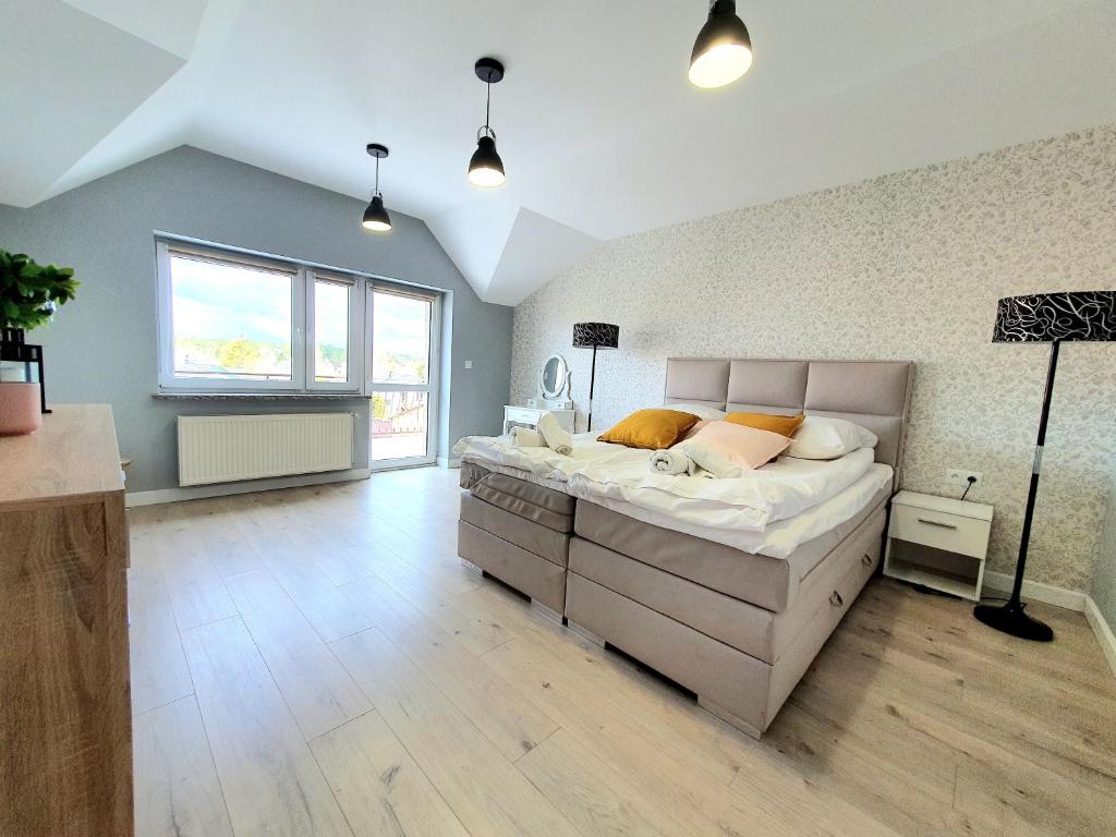 a bedroom with a large bed in a room at Prestige Apartament in Augustów