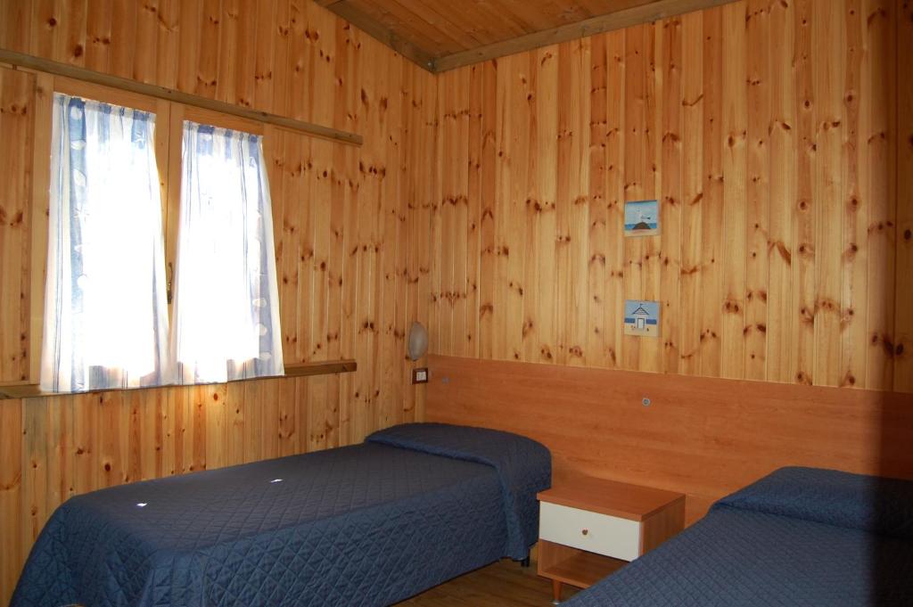 Postel nebo postele na pokoji v ubytování camping feniglia