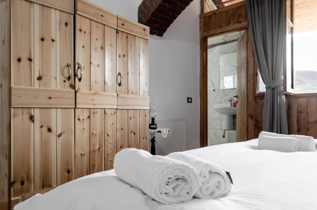a bedroom with a bed with white towels on it at Alpeta Agrotourism & Winery - Roshnik , Berat in Berat