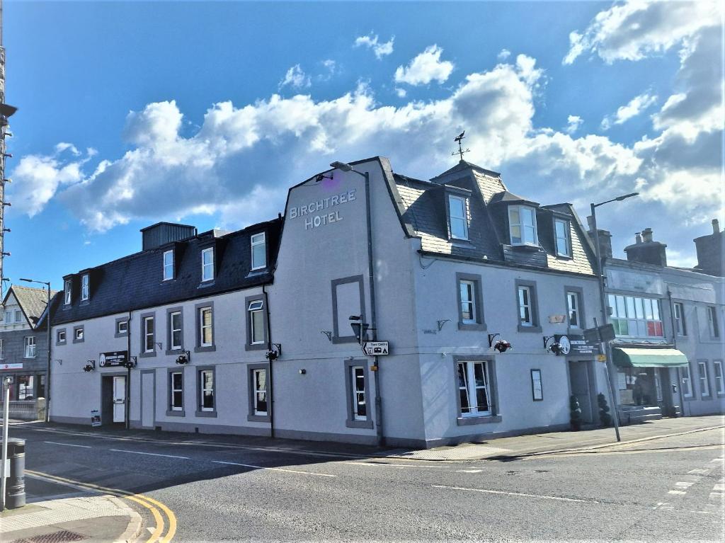 a white building on the side of a street at The Birchtree Hotel in Dalbeattie
