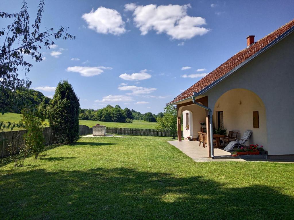 a house with a yard with green grass at Casa Maia Kosmaj in Dučina