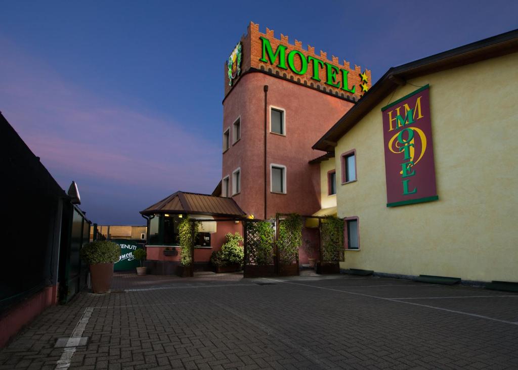 a motel with a sign on the side of a building at Hotel Motel Del Duca in Cava Manara