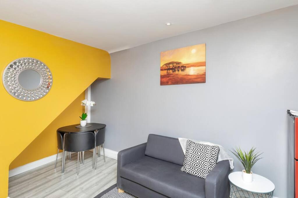 a living room with a couch and a yellow wall at Luxury Living - Lovely 1 Bedroom Apartment in Stockton-on-Tees