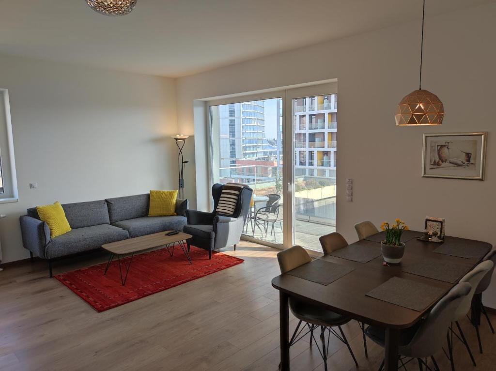 a living room with a table and a couch at Riverside apartment by the Danube in Budapest