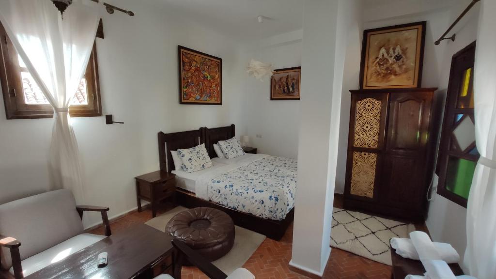 a bedroom with a bed and a living room at Casa Bellavista Chaouen in Chefchaouene