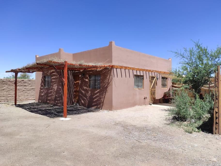 a small house in the middle of a field at Casa Soleña in San Pedro de Atacama