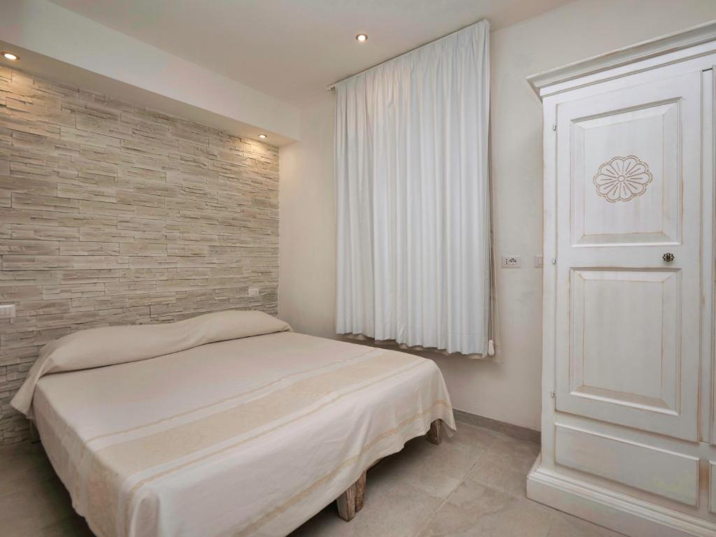 Łóżko lub łóżka w pokoju w obiekcie Iside Accommodations