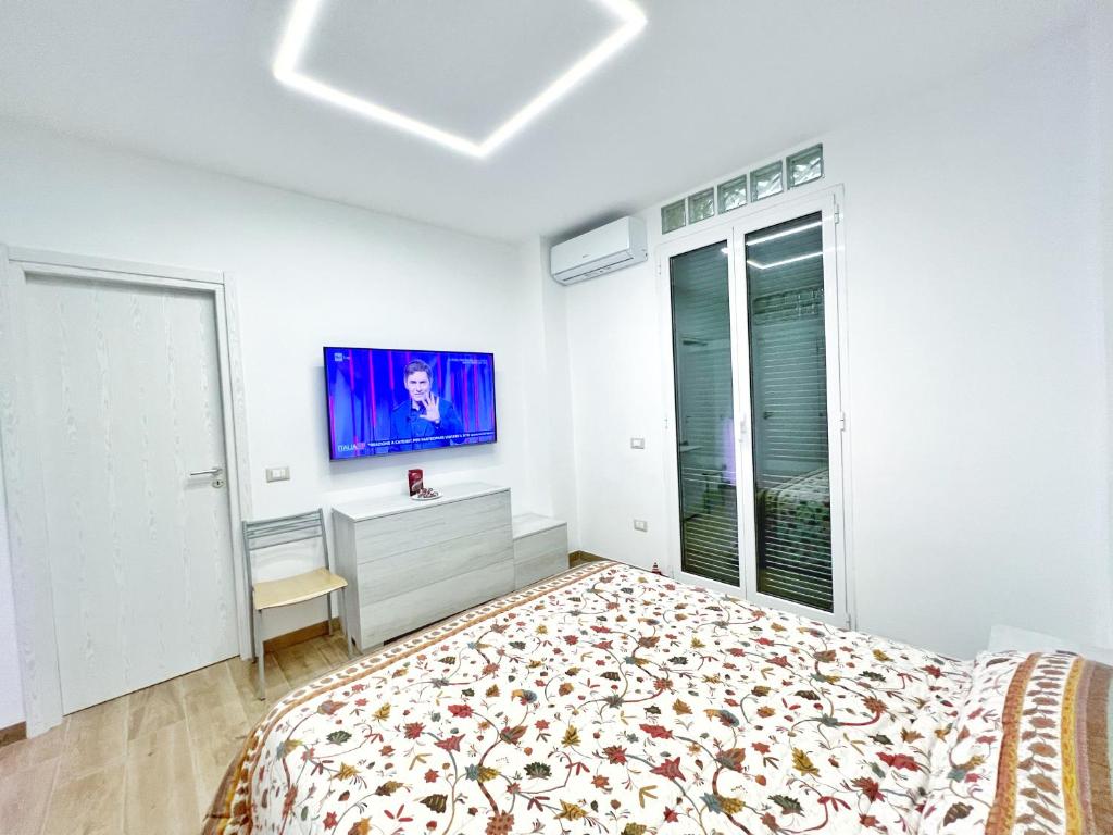 a bedroom with a bed and a tv on the wall at Luxury Tugurio in Arma di Taggia