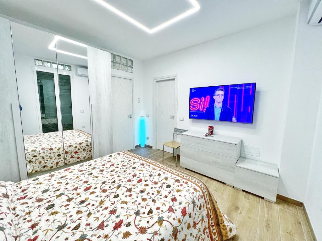 a bedroom with a bed and a tv on a wall at Luxury Tugurio in Arma di Taggia
