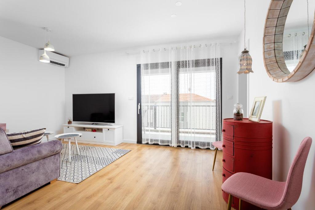 Televízia a/alebo spoločenská miestnosť v ubytovaní Villa Mare's 2