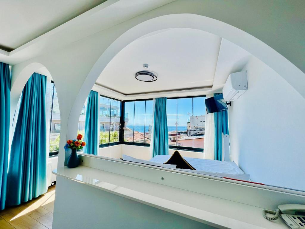 a bedroom with a large window with blue curtains at Apex Hotel in Istanbul