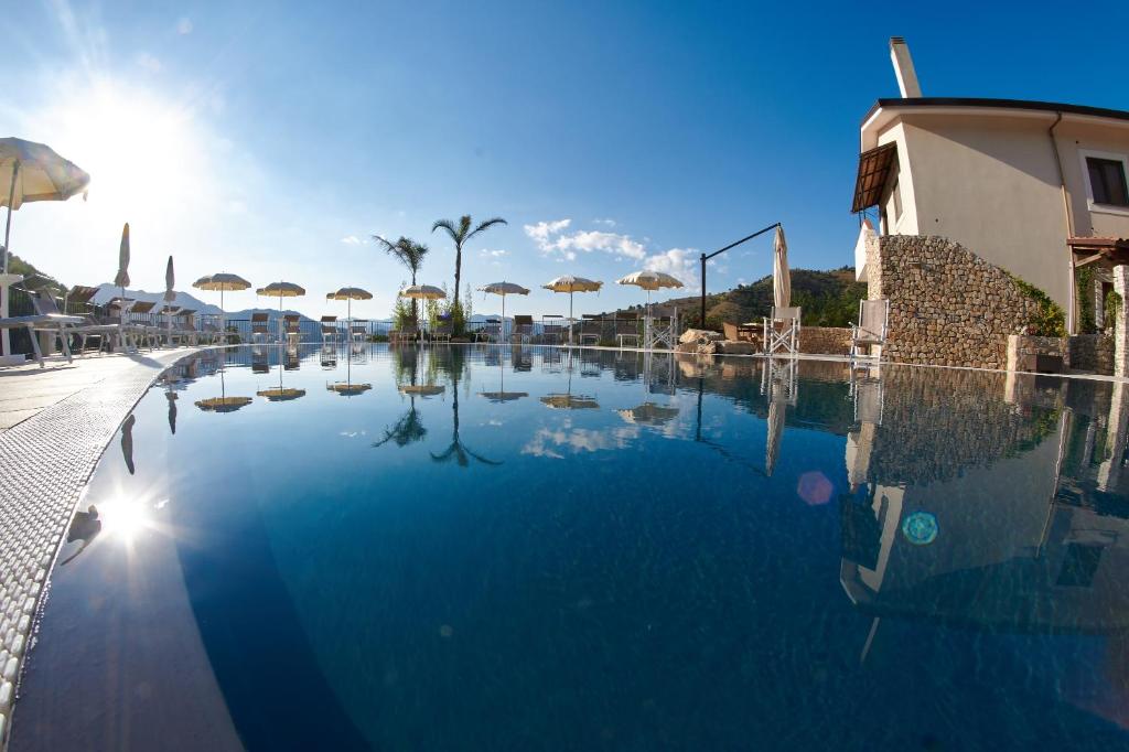 a swimming pool with umbrellas in a resort at Il Casale Della Stella in Baronissi