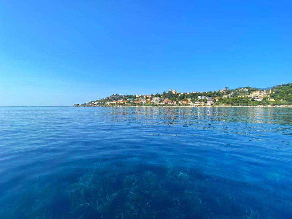 a large body of water with an island in the distance at Luxury Tugurio in Arma di Taggia