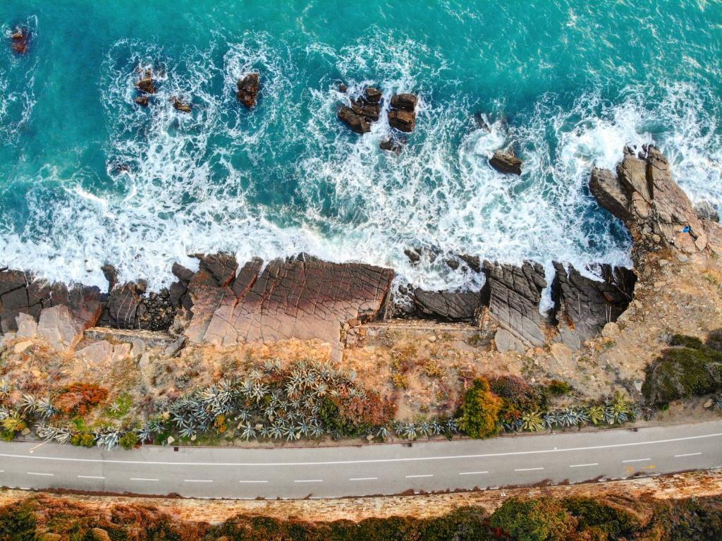an aerial view of the ocean and rocks at Luxury Tugurio in Arma di Taggia
