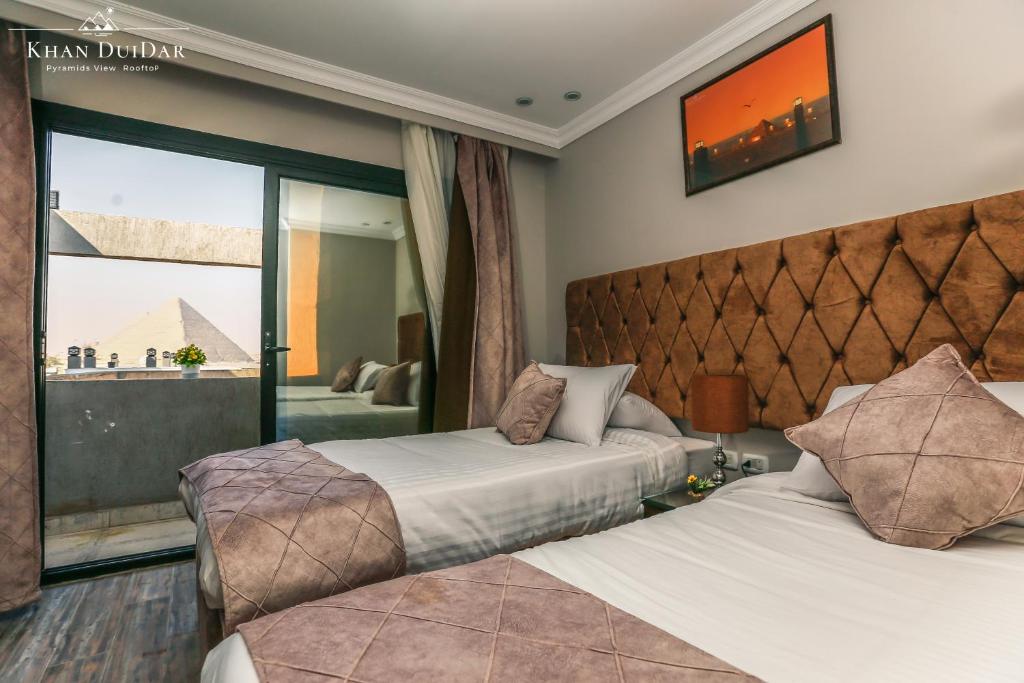 Uma cama ou camas num quarto em Khan Duidar Inn - Pyramids View Rooftop