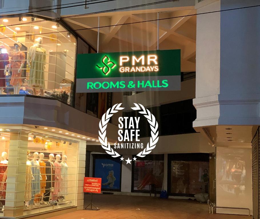 a store front with a sign for rooms and halls at PMR GRANDAYS in Malappuram