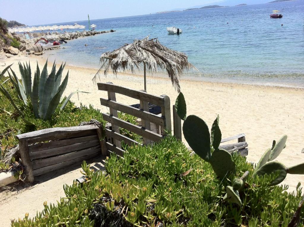 een houten hek op een strand met de oceaan bij Agrelia House in Ouranoupoli