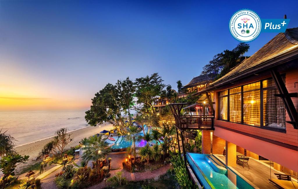 a hotel with a view of the beach at night at Nirvana Beach Resort, Koh Lanta SHA Extra Plus in Ko Lanta