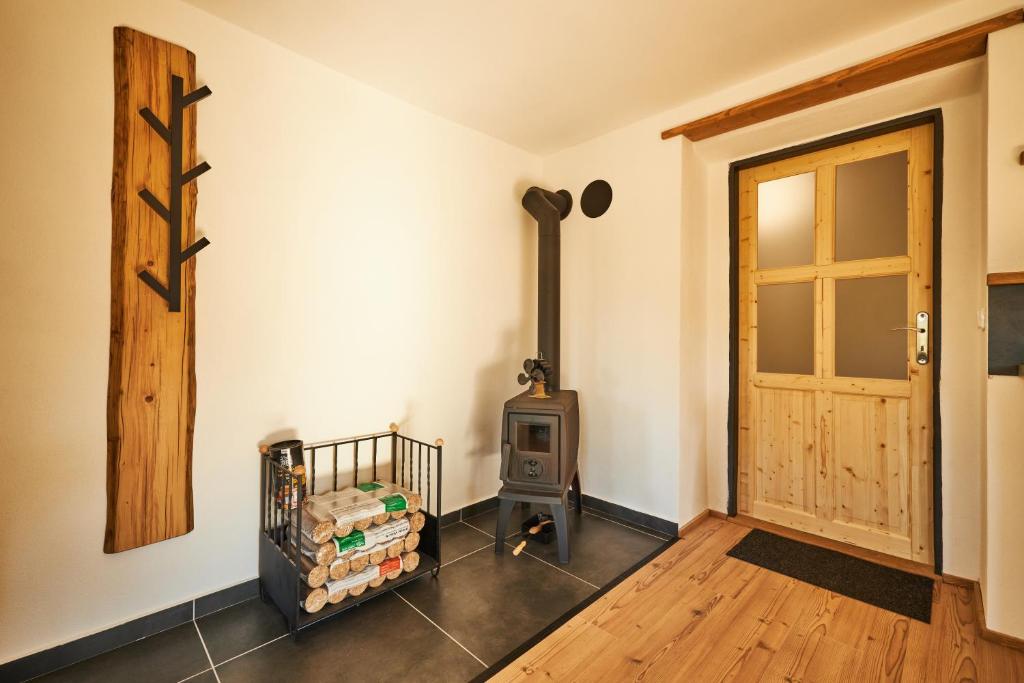 a room with a wood stove and a door at Statek 85 in Mařenice