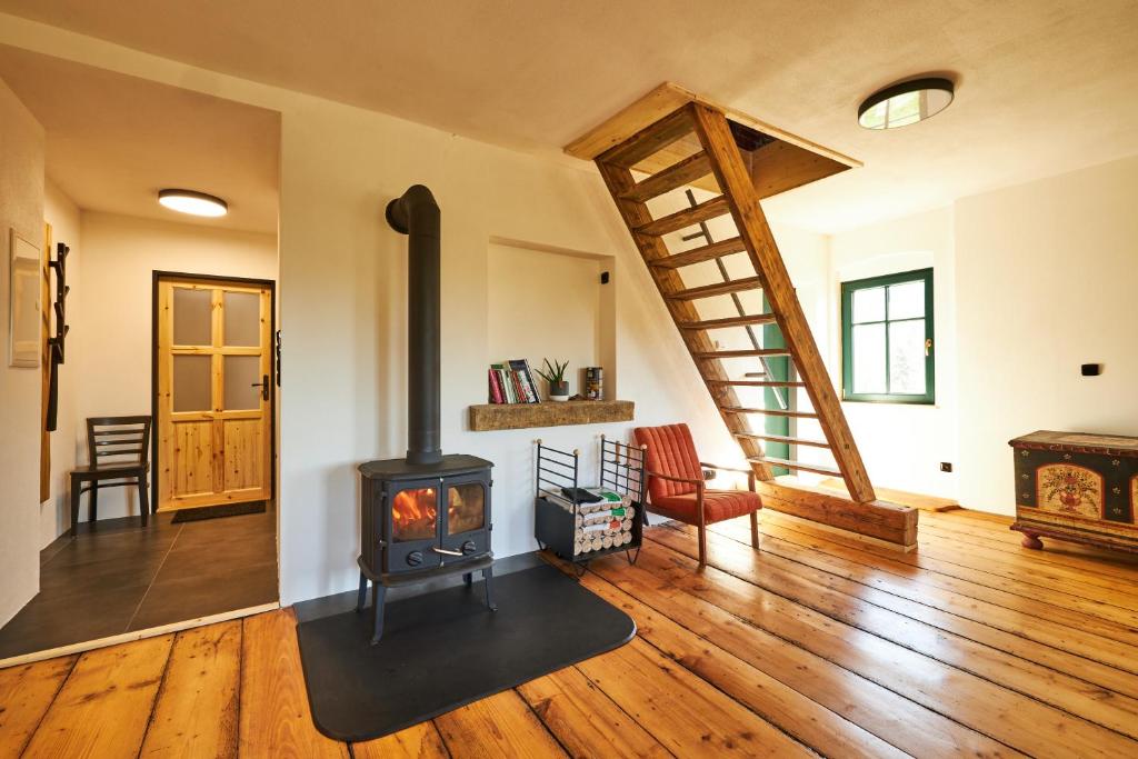 a living room with a wood stove in it at Statek 85 in Mařenice