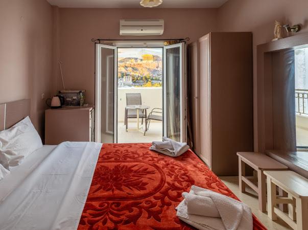 a bedroom with a large bed and a balcony at Fantastic Matala 1 in Matala