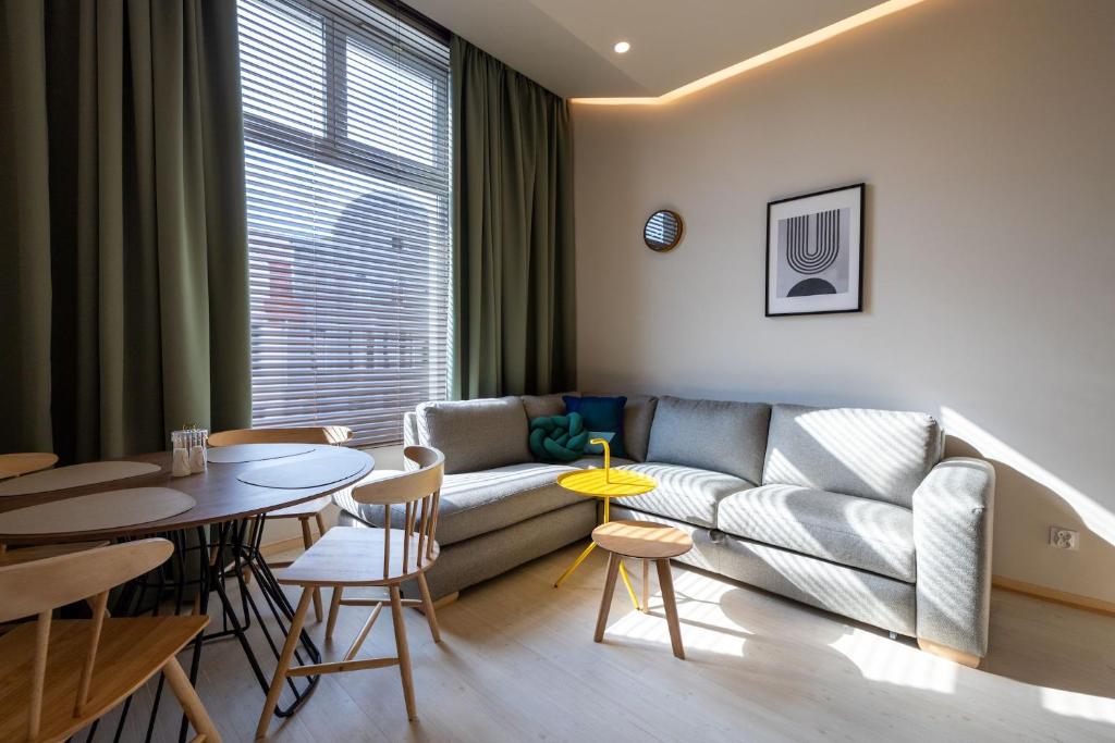 a living room with a couch and a table at WAM Apartments in Giżycko