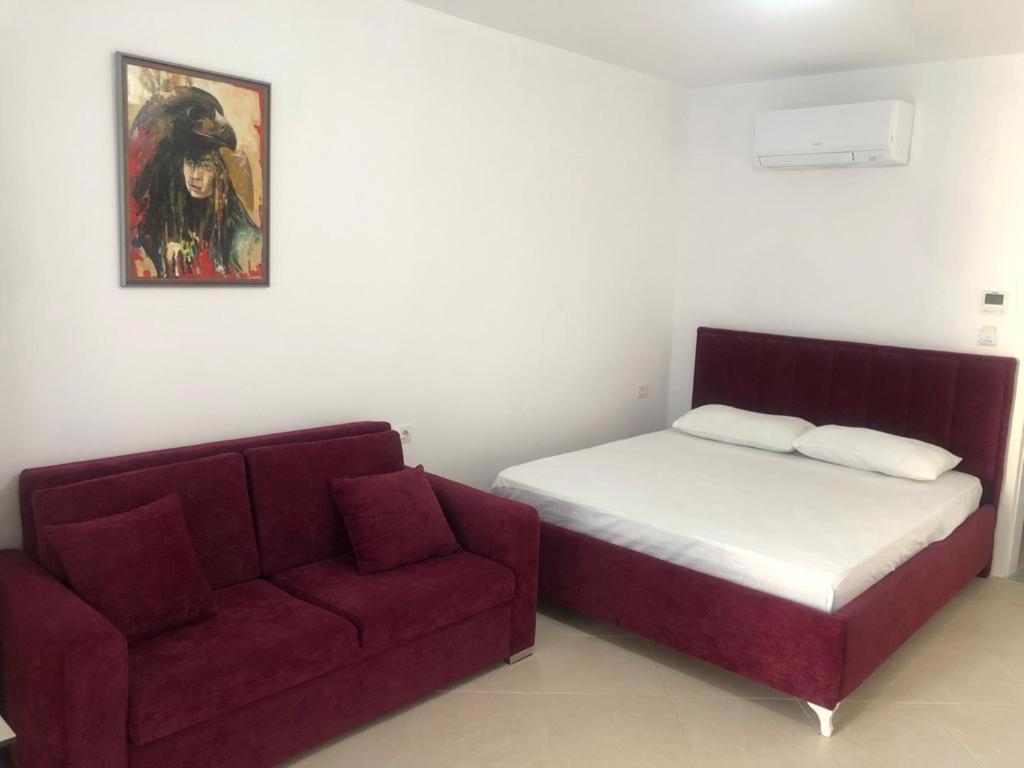 a bedroom with a bed and a couch at Hotel MARIO, Shengjin in Shëngjin