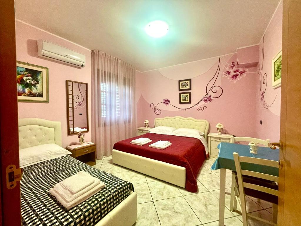 B&B Villa Ciccone في Villamagna: غرفة نوم بسريرين وطاولة فيها