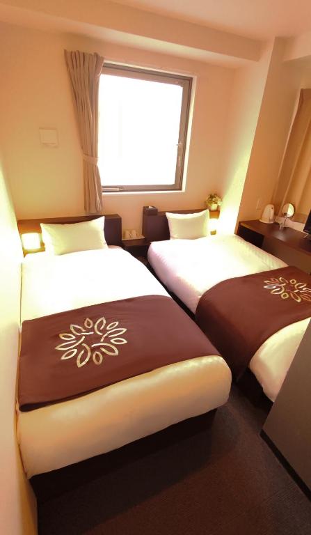 Postel nebo postele na pokoji v ubytování Floral Hotel · SakaisuJi-Honmachi Osaka