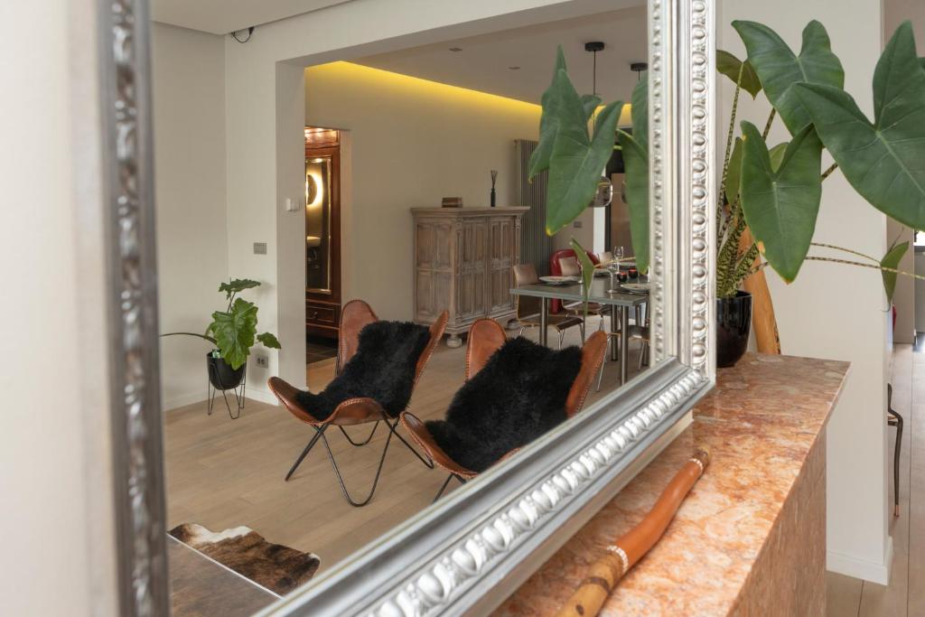 a mirror with two chairs in a living room at #MacLeod2 in Ostend