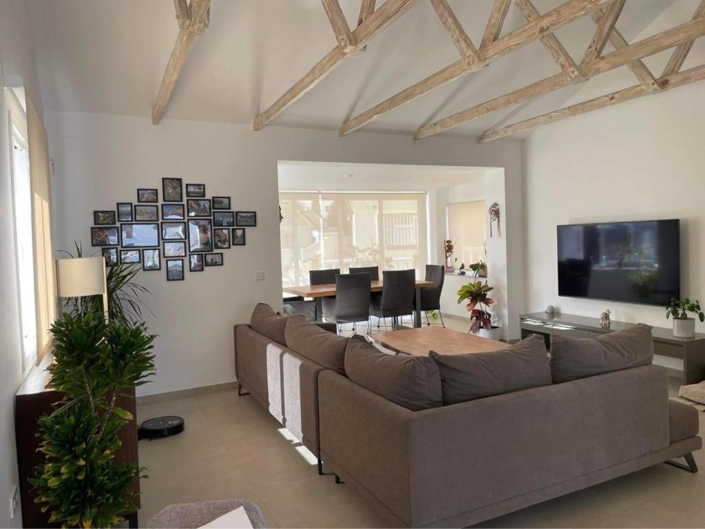 a living room with a couch and a table at Chalet del Sol en El Faro in Mijas Costa