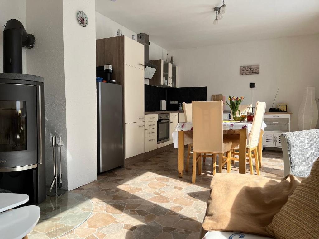 a kitchen and living room with a table and chairs at Ferienanlage Geisingblick in Geising