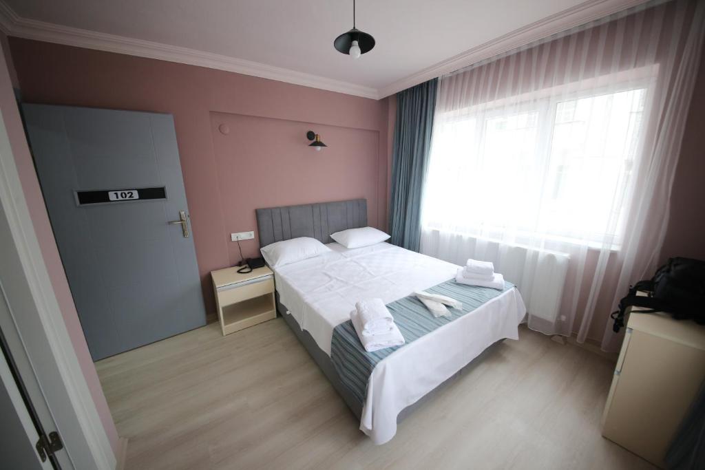 a bedroom with a white bed and a window at Stay Inn Edirne in Edirne