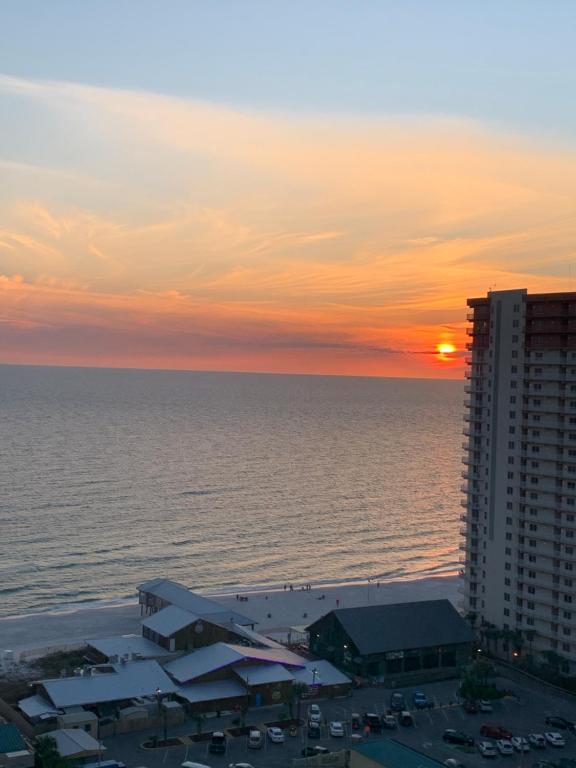 a sunset over the ocean and a building at Laketown Wharf 1717 in Panama City Beach