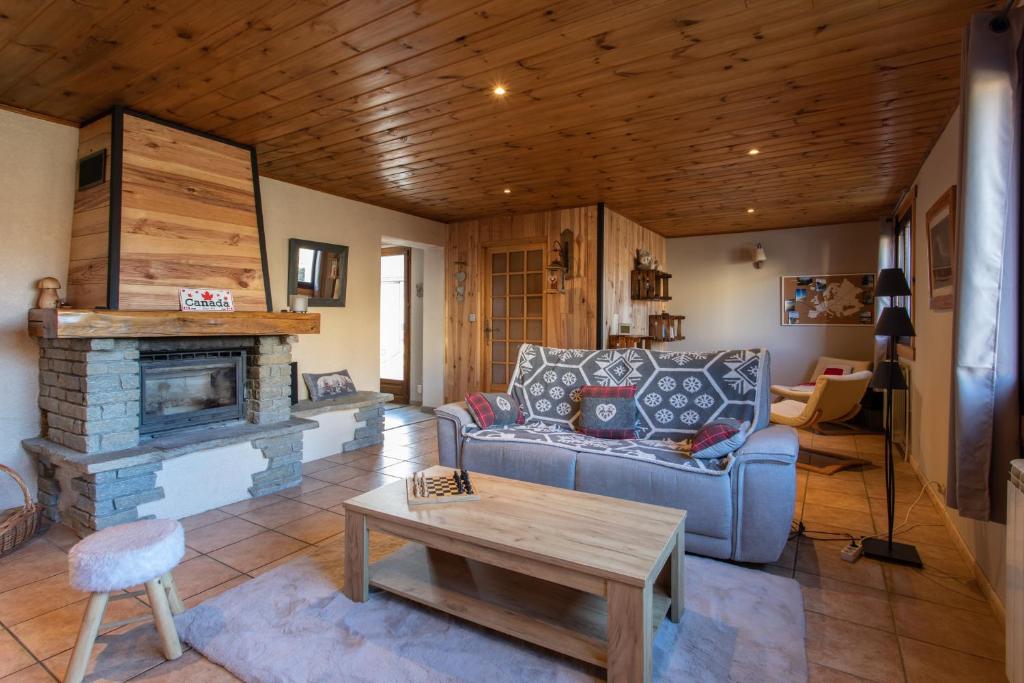 a living room with a couch and a fireplace at Le Brec in Barcelonnette