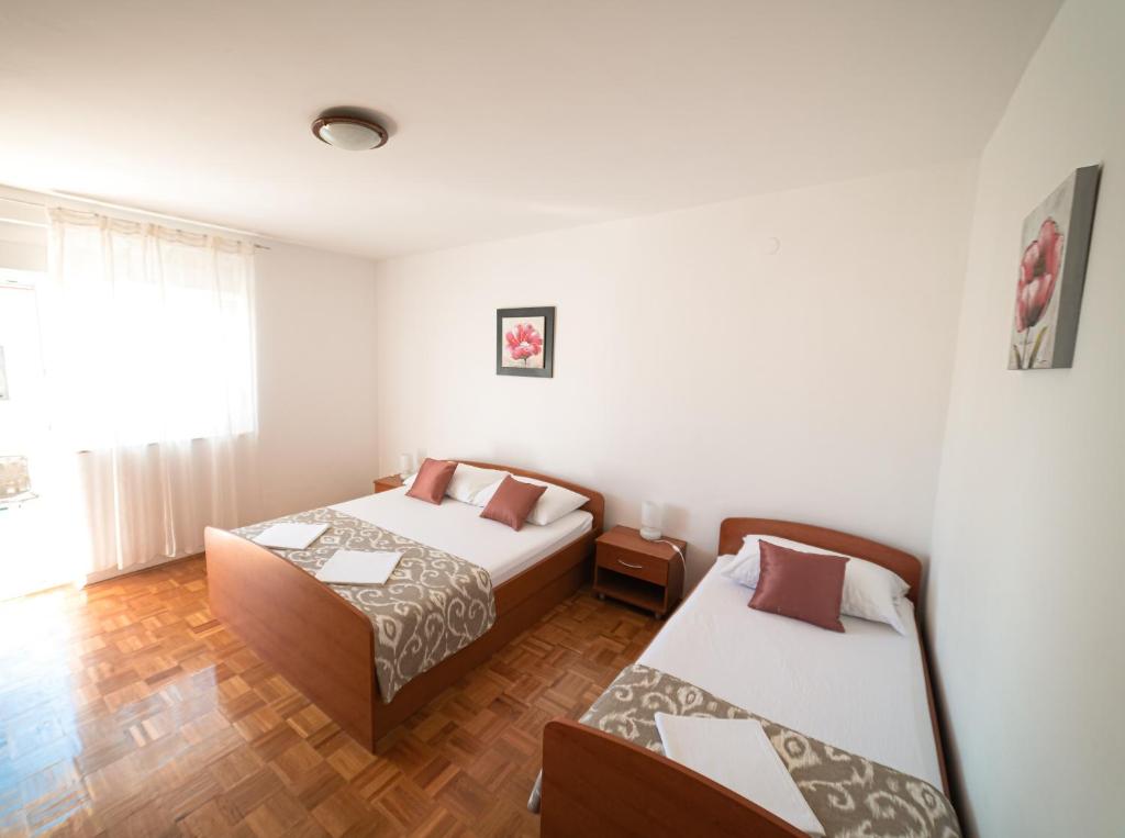 Postel nebo postele na pokoji v ubytování Apartments M&S