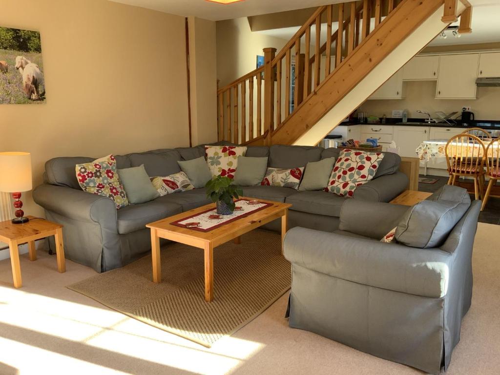 a living room with a couch and a table at Magnolia Cottage in Launceston
