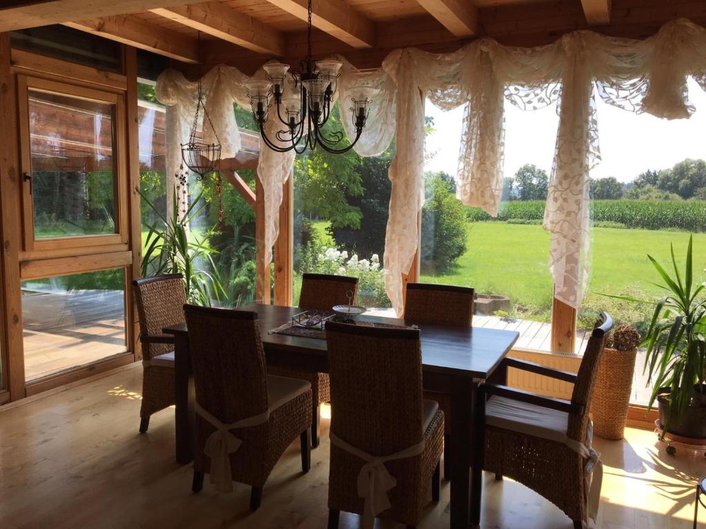 a dining room with a table and chairs and a large window at Wein-Chalet W141 in Weinburg am Saßbach