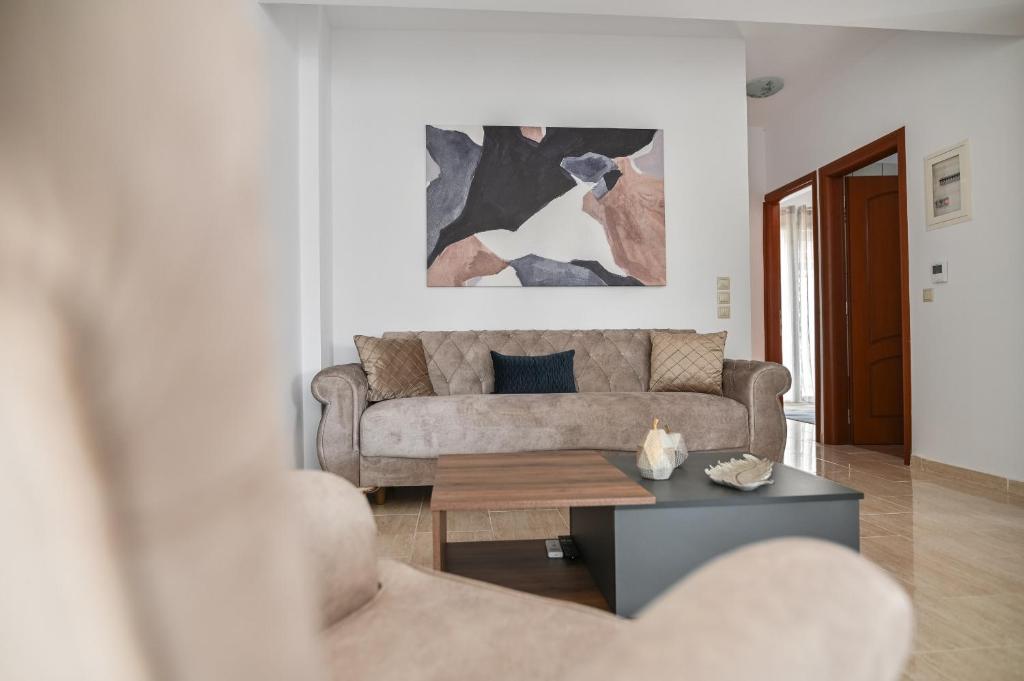 a living room with a couch and a coffee table at Oliva Apartments in Makri