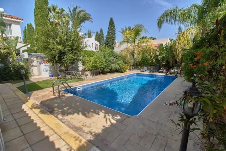 a swimming pool in the backyard of a house at Cheerful 3 bdr villa near the beach in Coral Bay