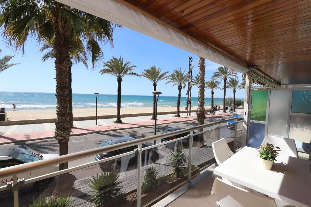 a balcony with palm trees and the beach at DIFFERENTFLATS Morsa in Salou