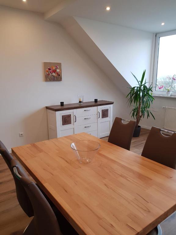 a dining room with a wooden table with chairs at Wolke 7 in Hattingen