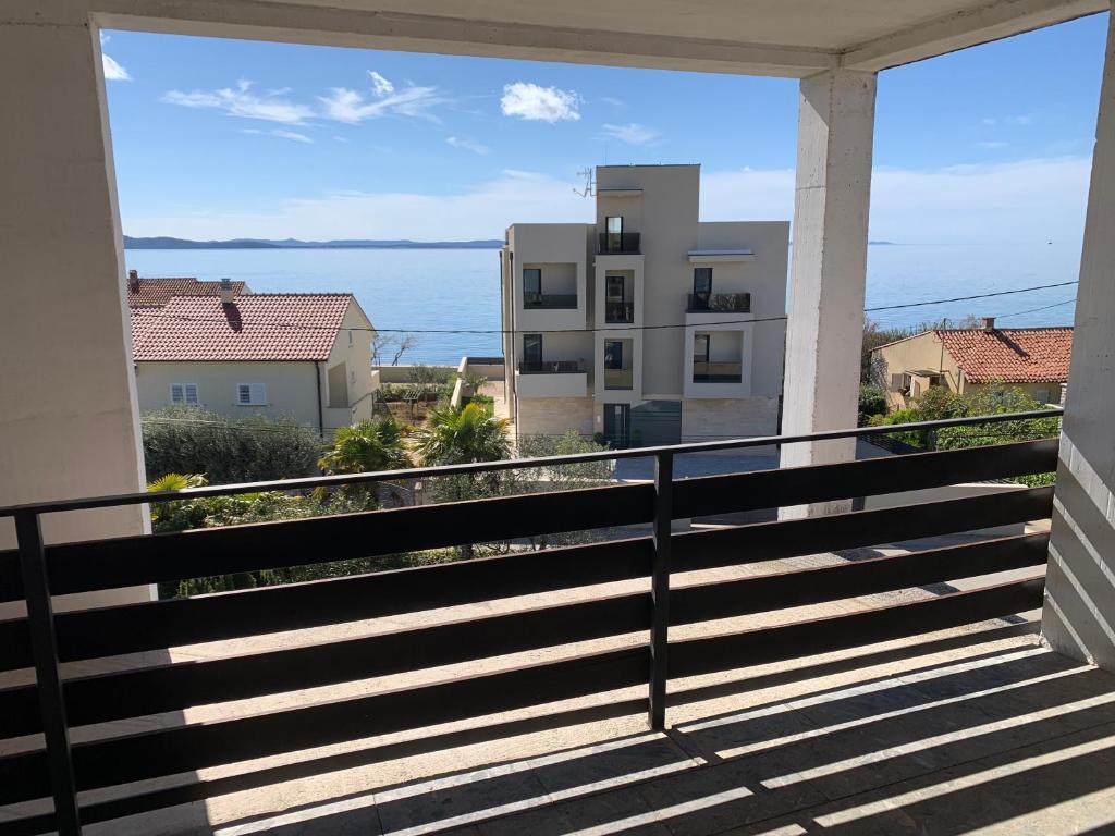a balcony with a view of the ocean at Apartments Vitez in Zadar