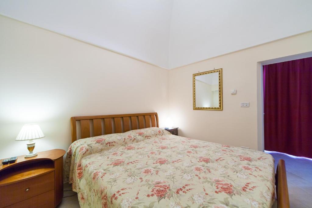 a bedroom with a bed and a table and a mirror at Sogno D'Epoca 1822 in Monopoli